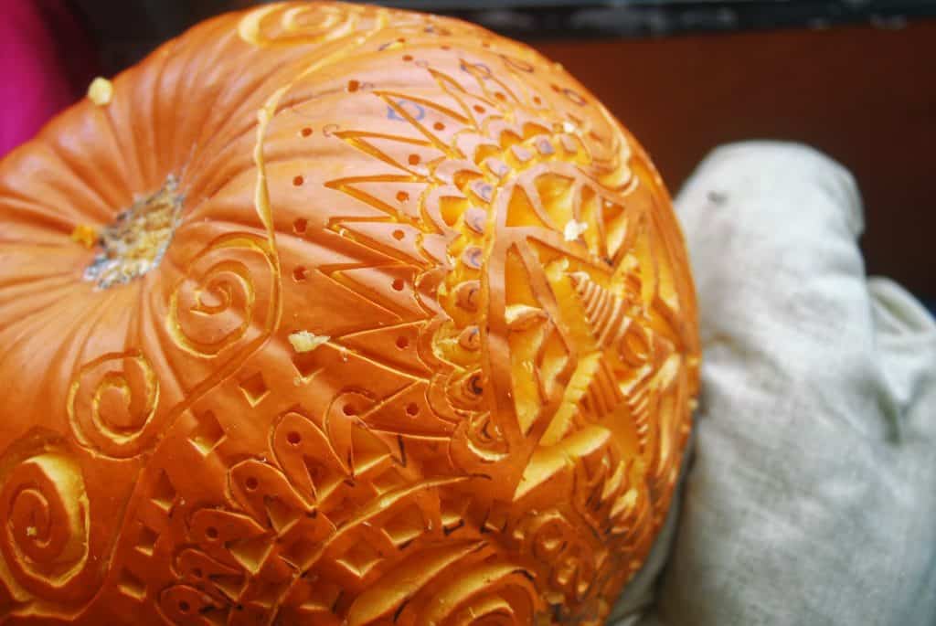 A pumpkin with intricate detail in the carving.